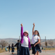 Holland, right, and a fellow Donald J. Meyer Elementary School student point out the airplane in the sky above them.